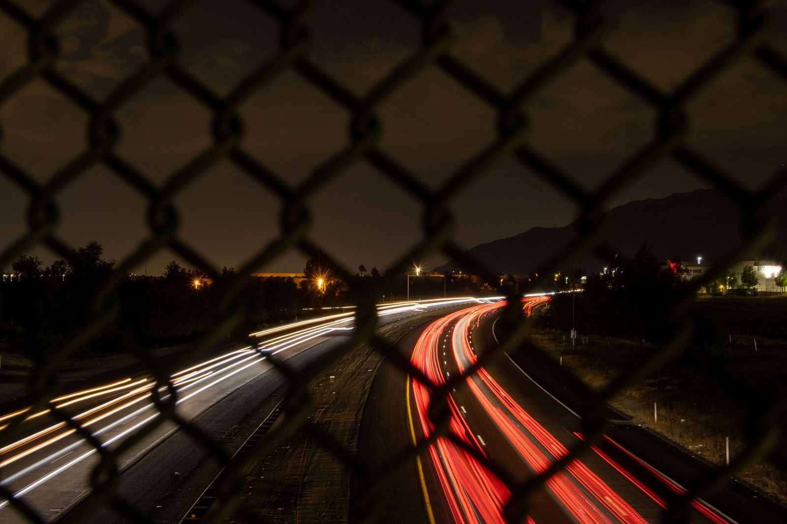 A black car on a highway at night; the westbound return from Pearson to St. Catharines is usually quicker after dark.