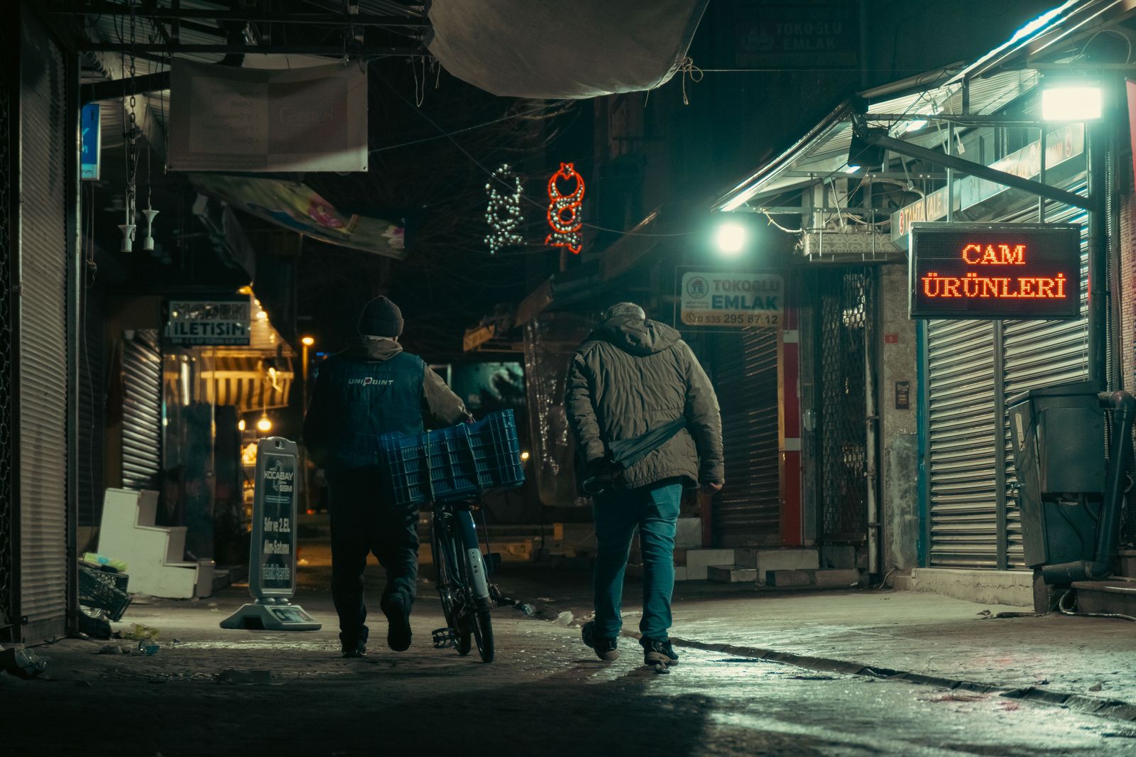 Friends walking down a lively city street on a warm evening