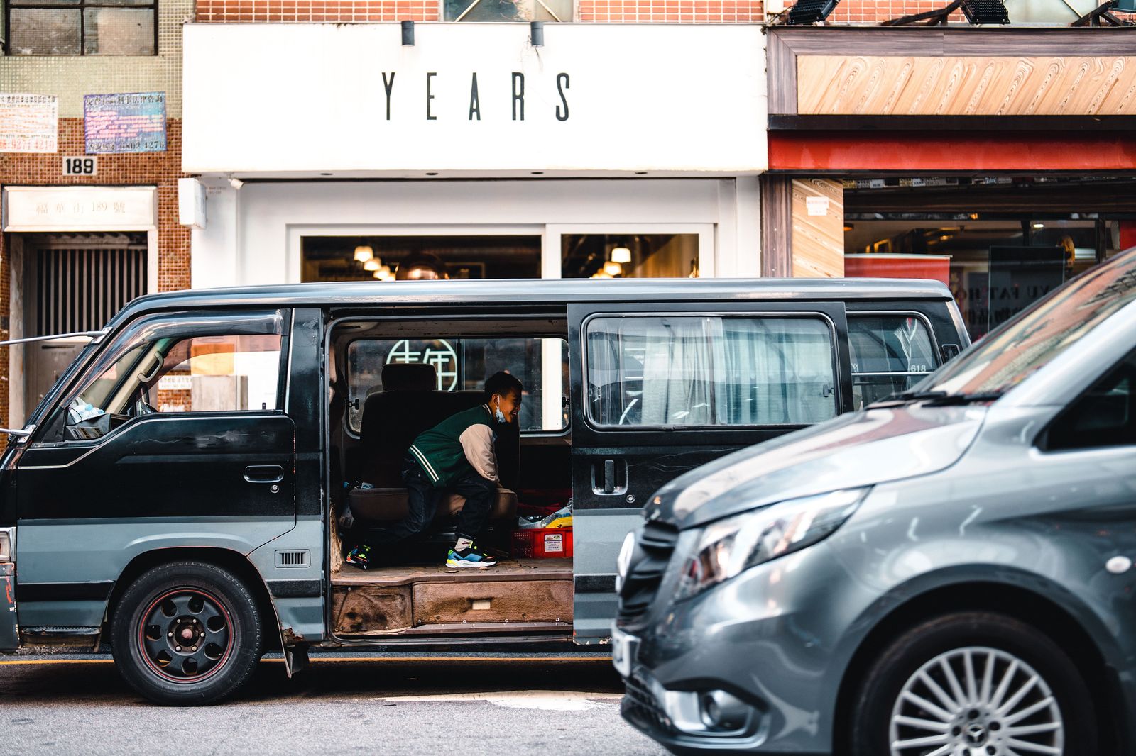 A luxury van with its sliding door open for easy access at the curb