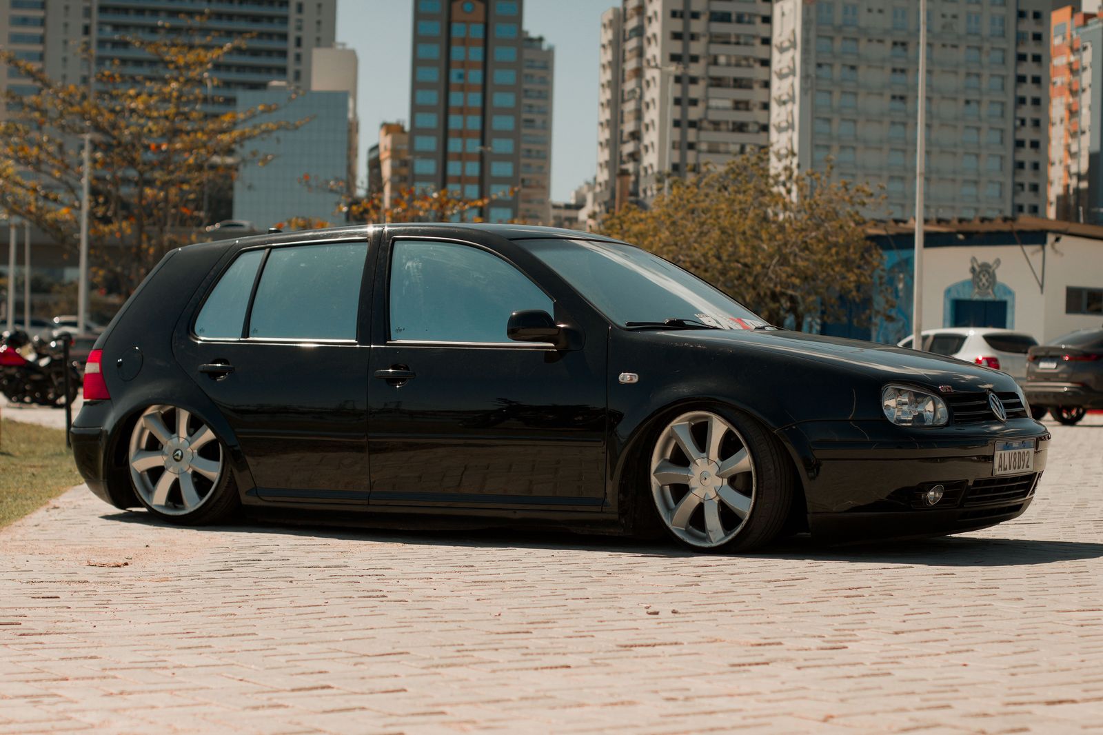 A black sedan waiting on a side street near the arena after a concert