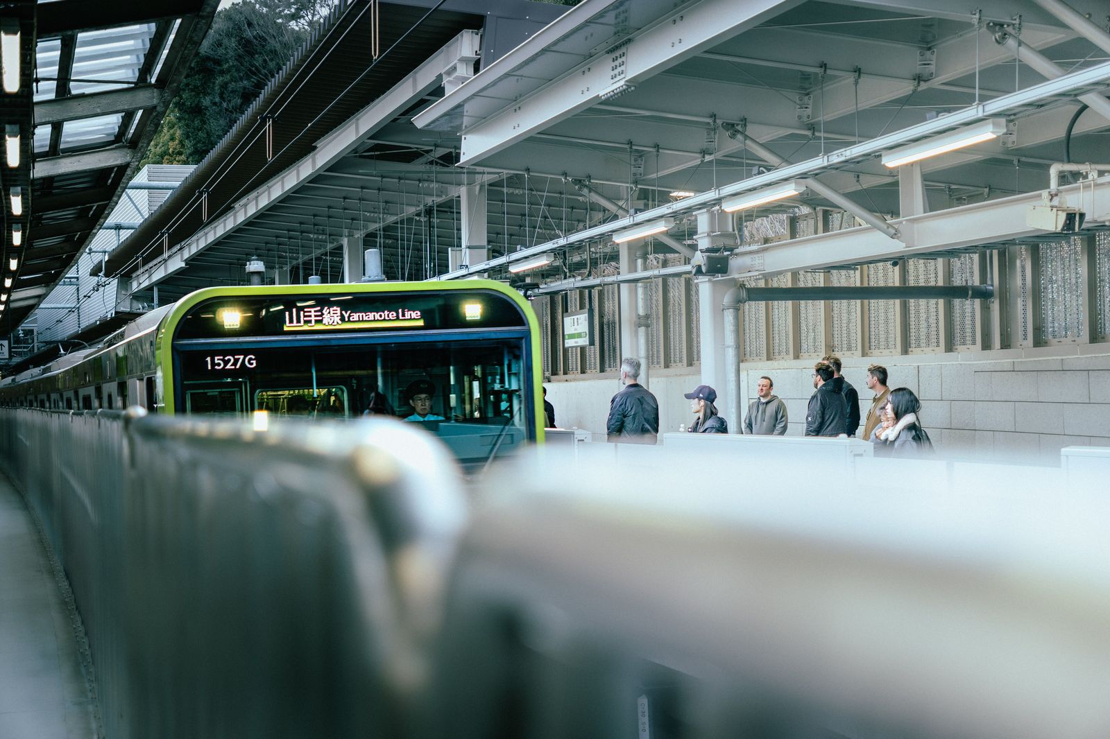 Commuters waiting on a GO train platform for a Toronto-bound train