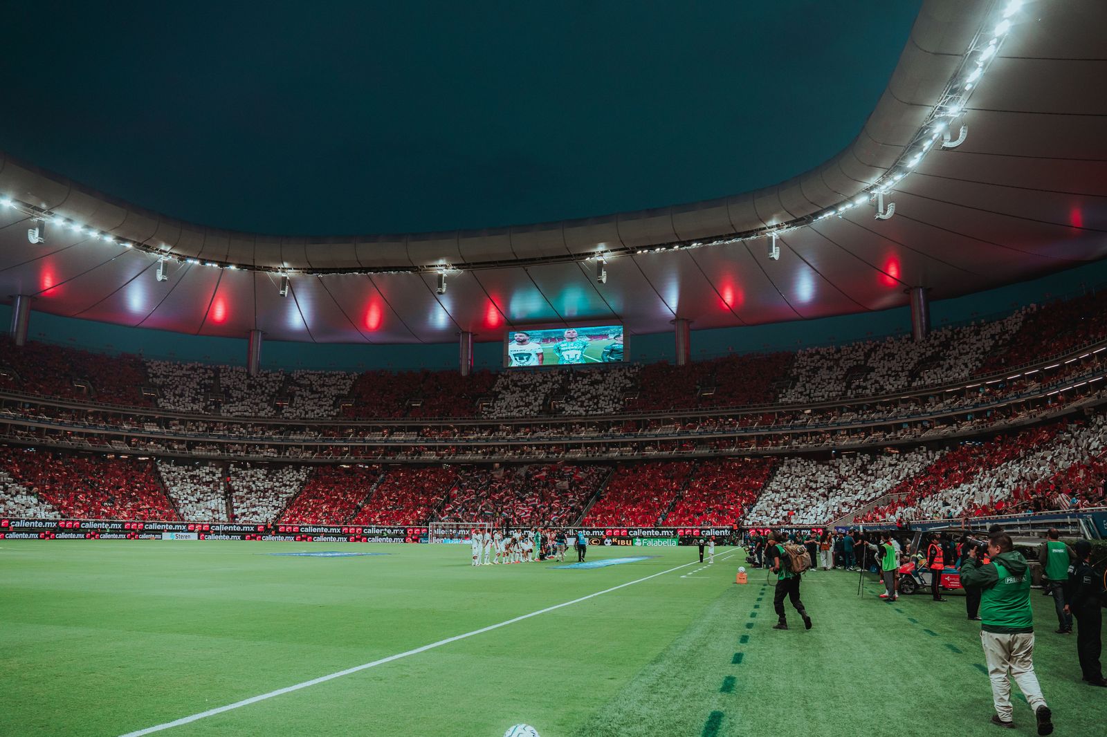 A packed stadium under lights on game night; booking the ride home before kick-off saves the scramble afterwards.