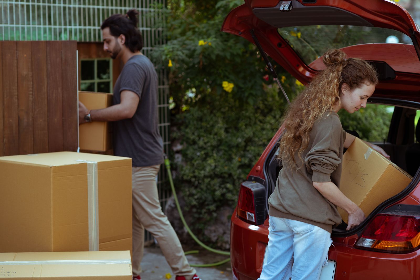 A family loading suitcases into an SUV in a Waterdown driveway before a Pearson flight