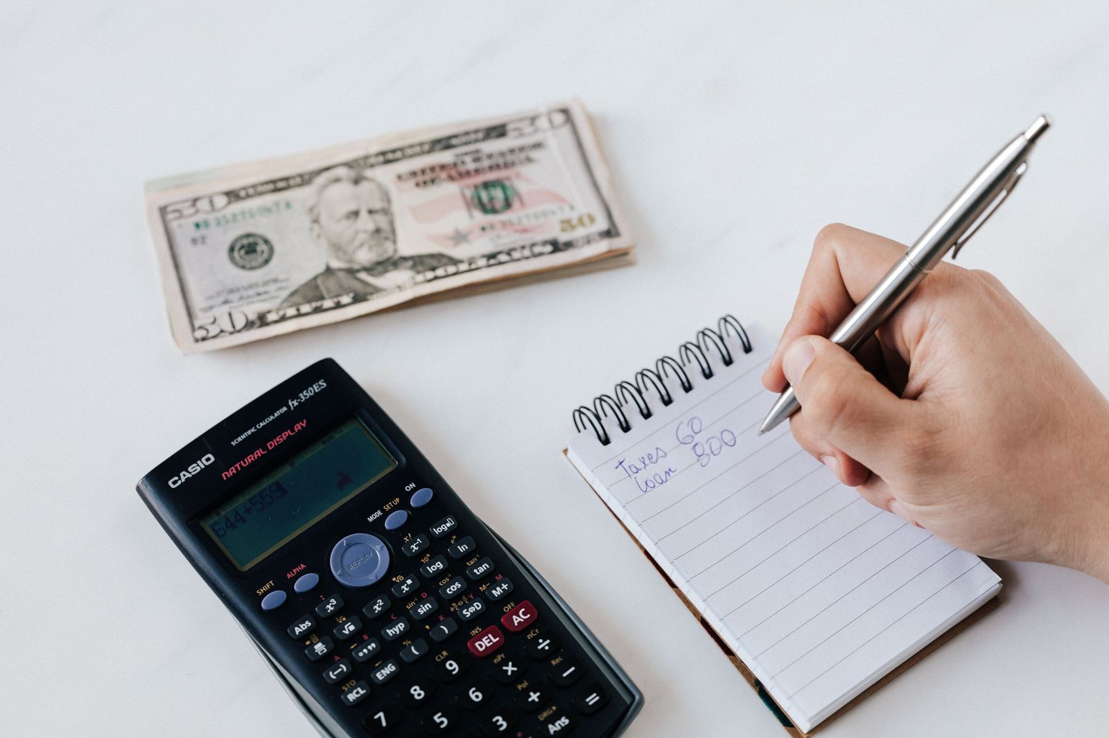 A wedding budget worksheet on a table with the transportation lines written out by vehicle and hour