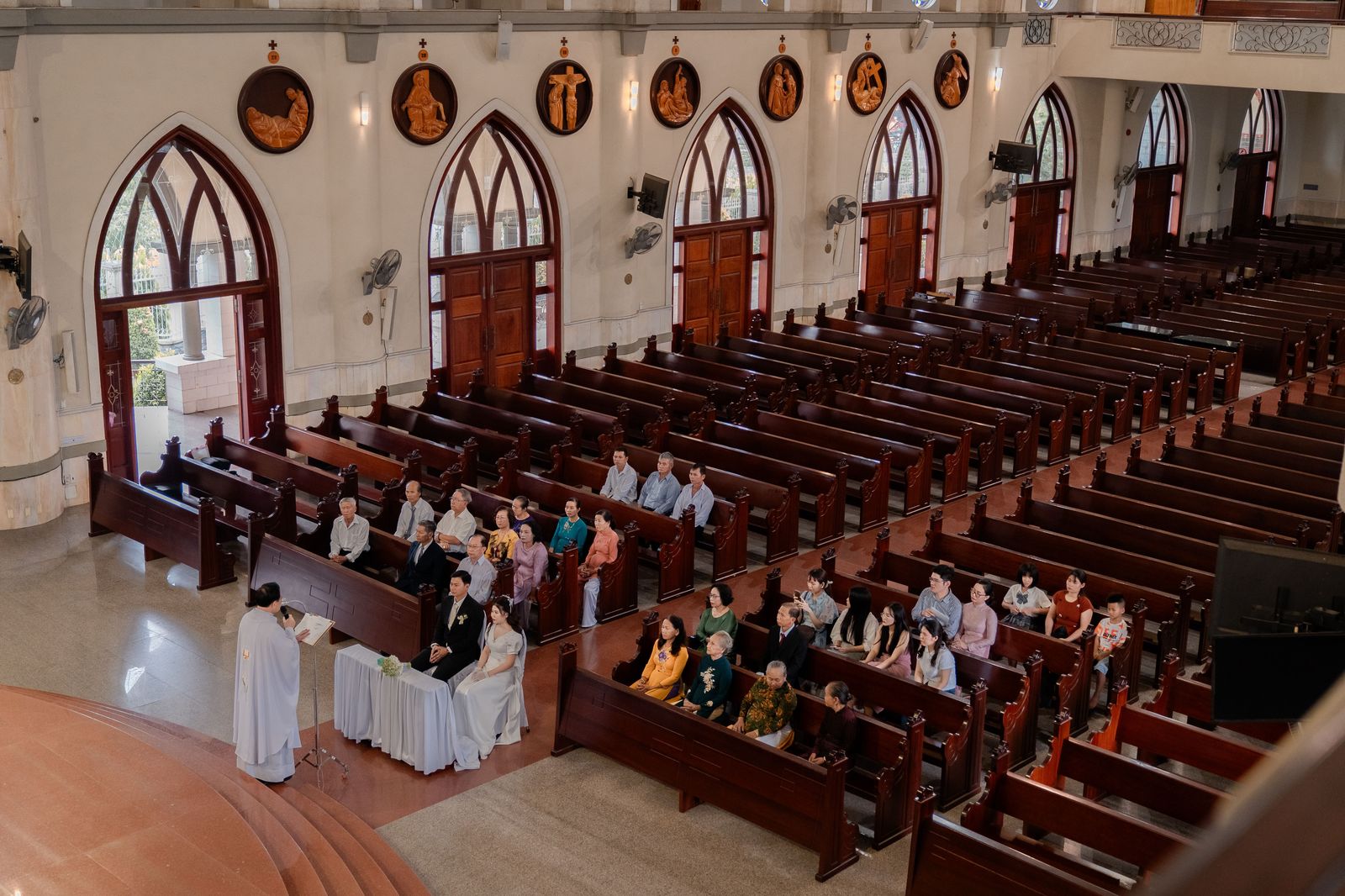 Guests seated in a church as a wedding ceremony begins, the one fixed time in the whole schedule