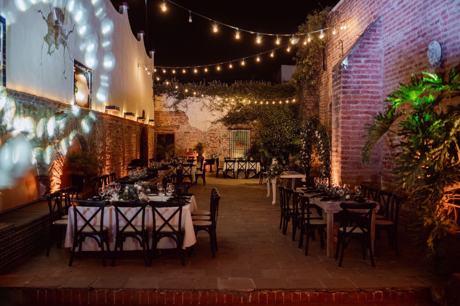 A reception room set with lights and tables, the point where the day's driving ends