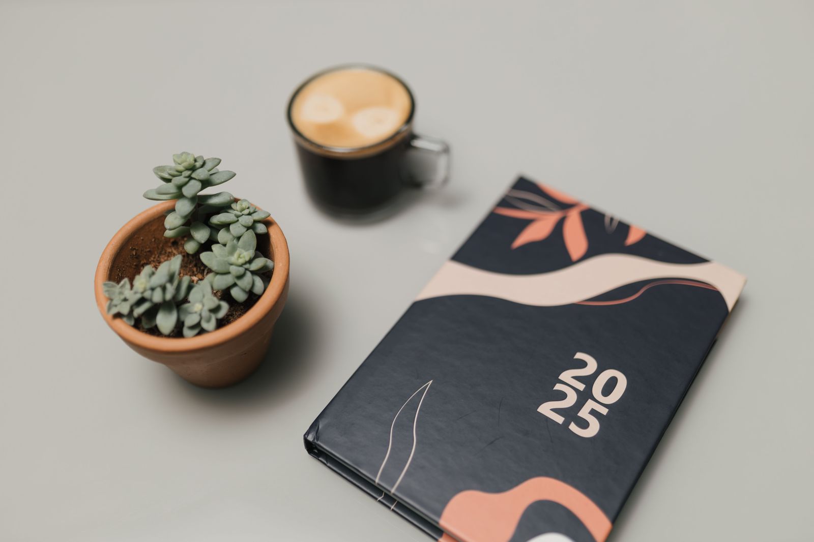 A phone calendar and a coffee on a table, planning a weekend of events in Hamilton