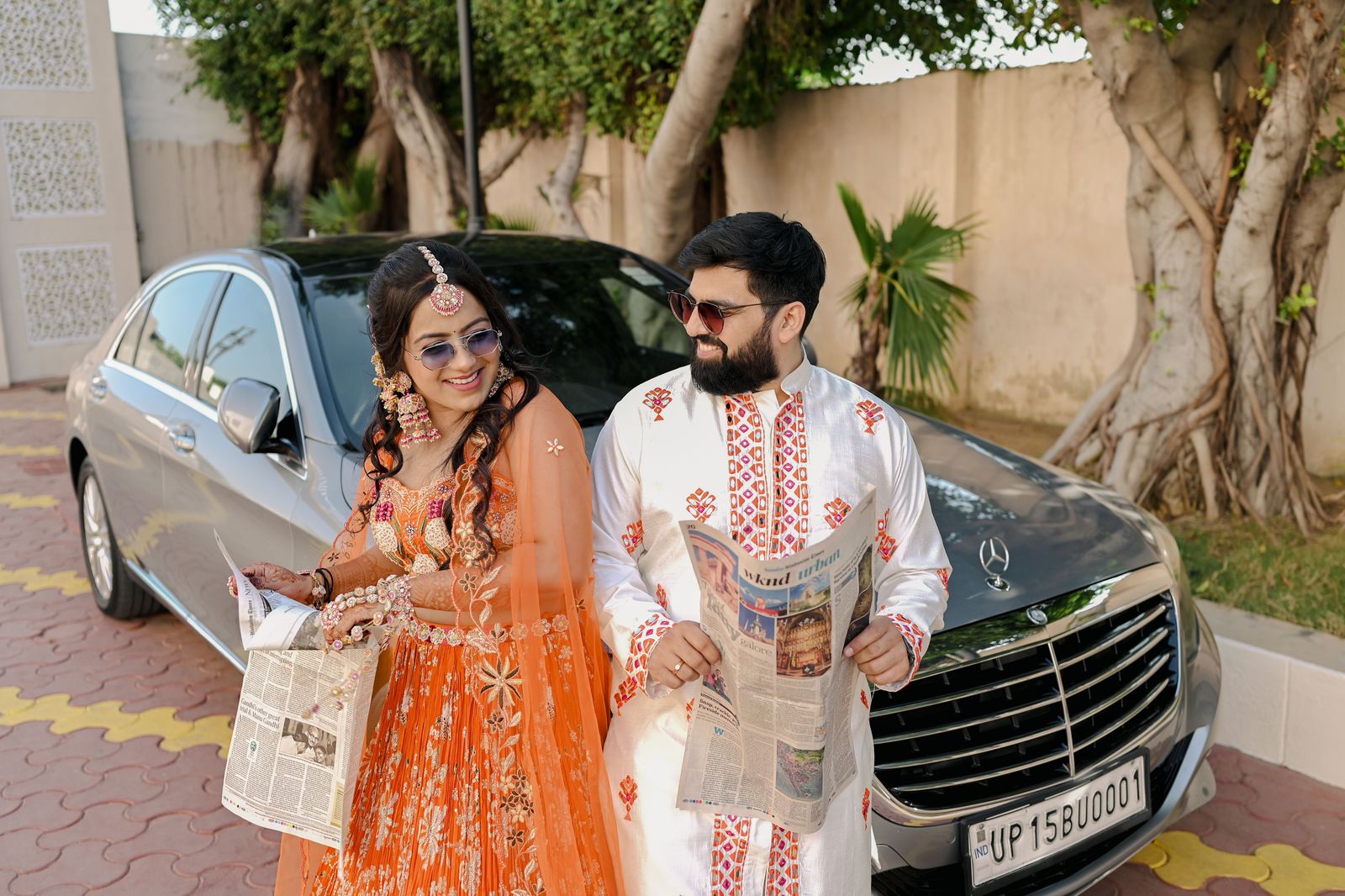 A decorated car for the couple at a South Asian wedding; the rest of the convoy follows in matching black vehicles.
