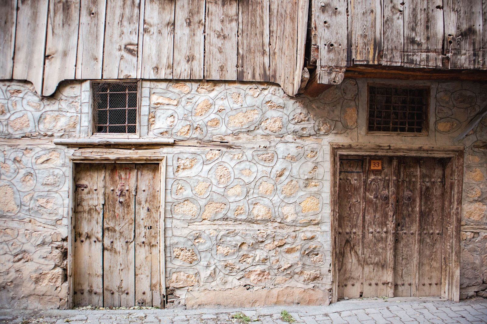 A cobblestone wall of river stones laid in mortar, the building style Paris, Ontario is known for.