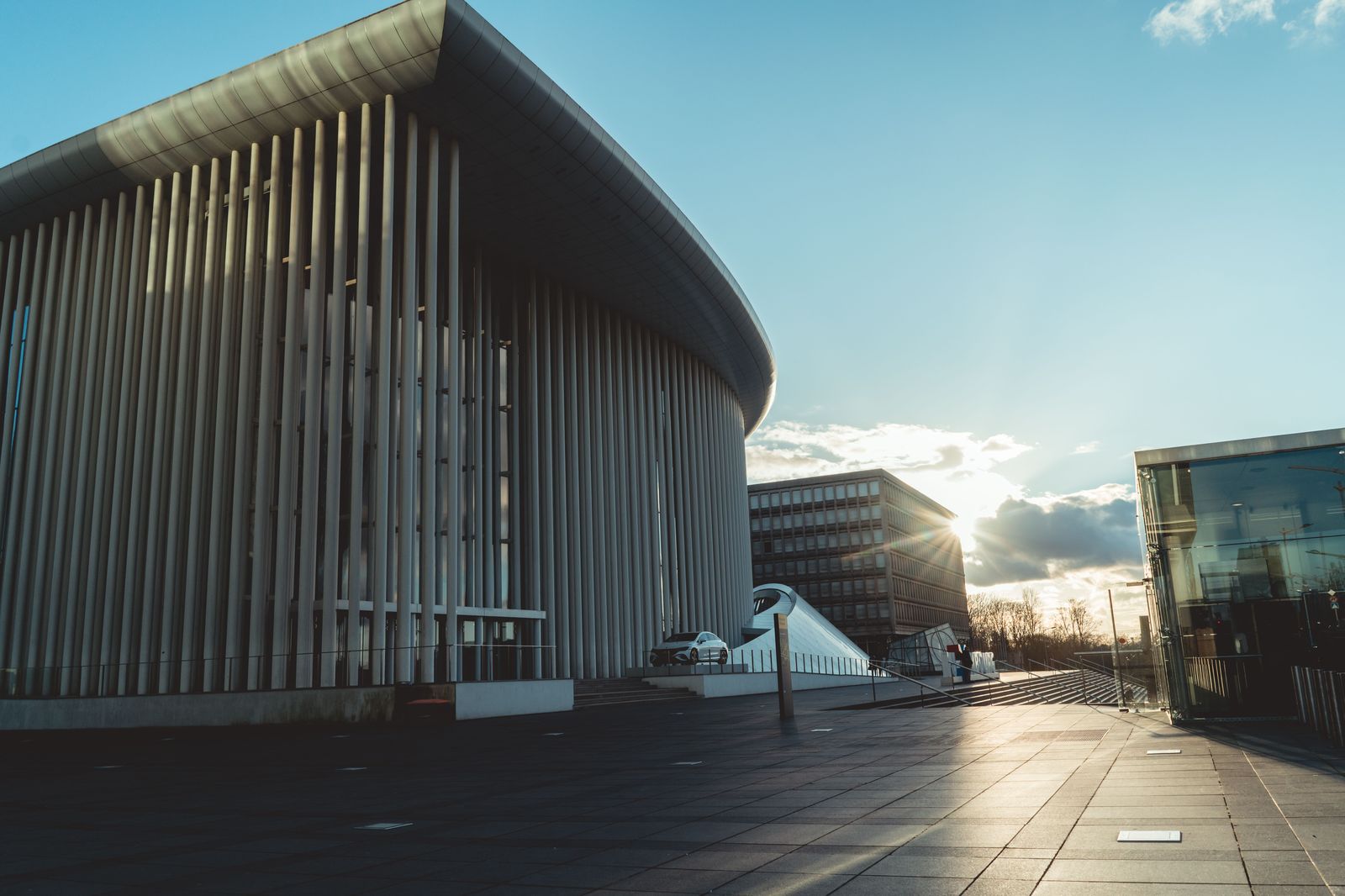 A modern concert hall downtown, where chauffeurs agree a pickup corner before the show ends.