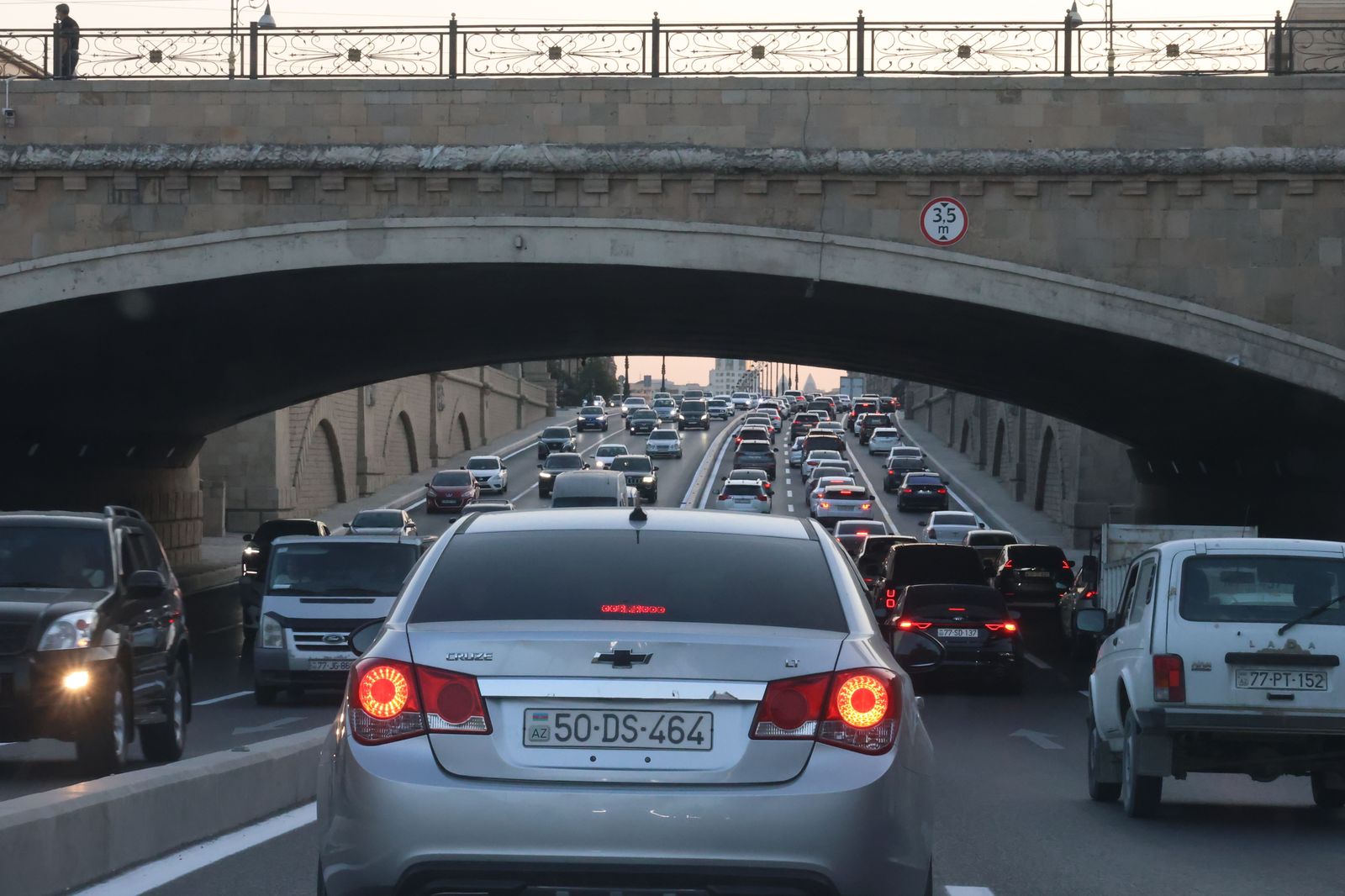 A black sedan on a highway overpass at dusk, the Highway 406 run between Welland and the QEW.
