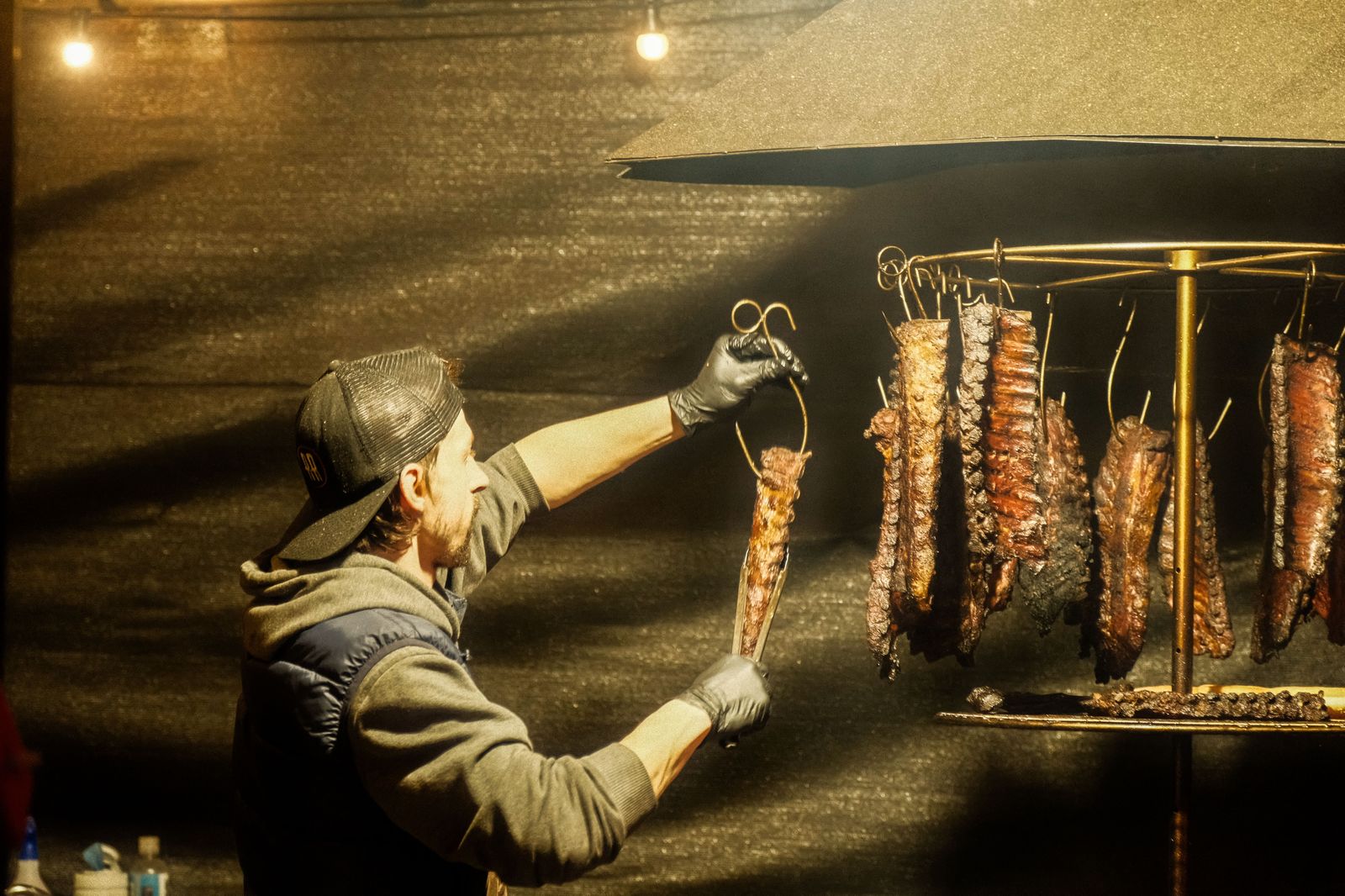 Rib teams grilling under smoke at a waterfront barbecue festival in Burlington