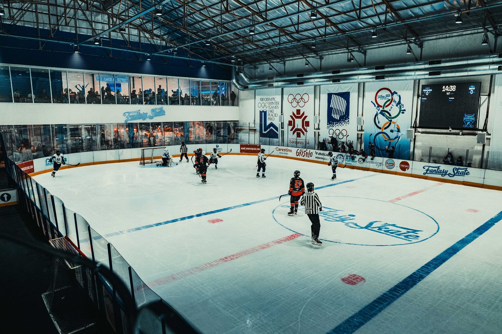 Hockey game under the lights at a busy downtown arena