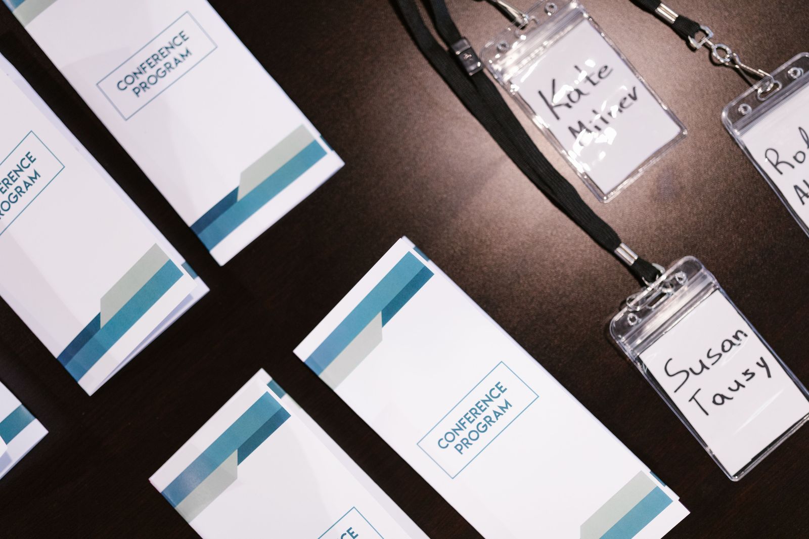Conference delegates with name badges talking between sessions in a convention hall