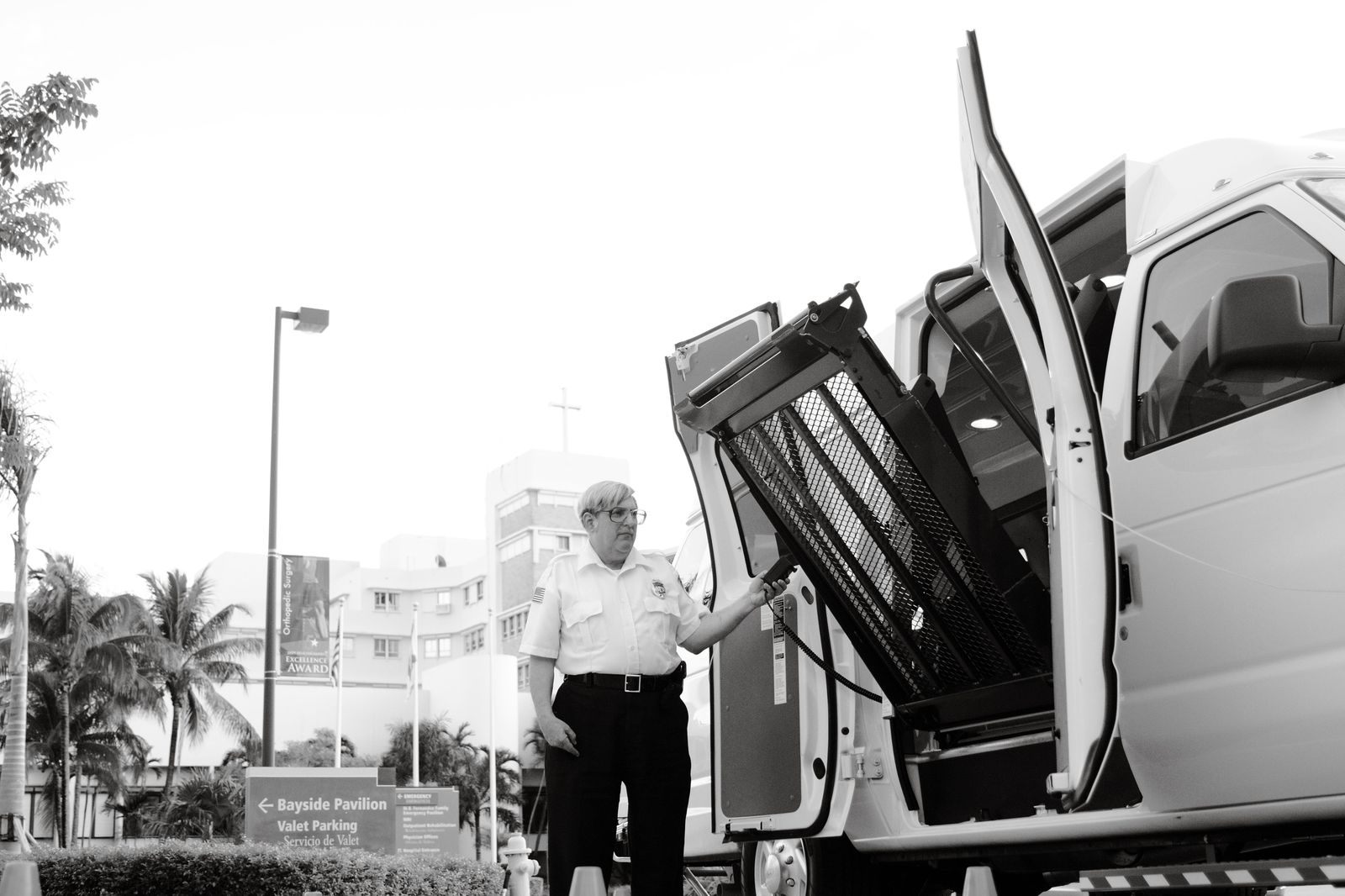 Black Sprinter van waiting at a hotel entrance to shuttle conference delegates