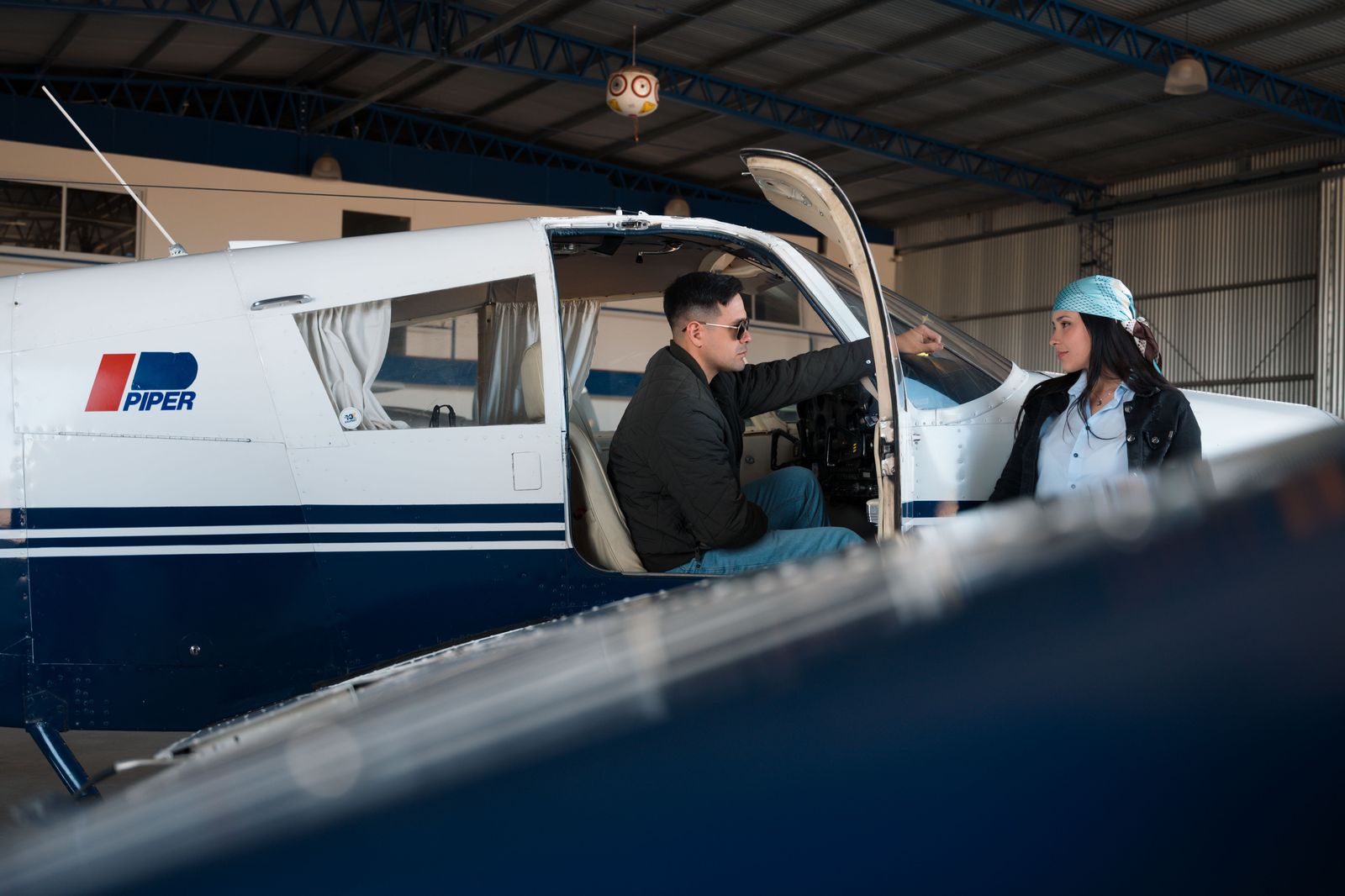 A pilot walking from the airfield toward a waiting black sedan