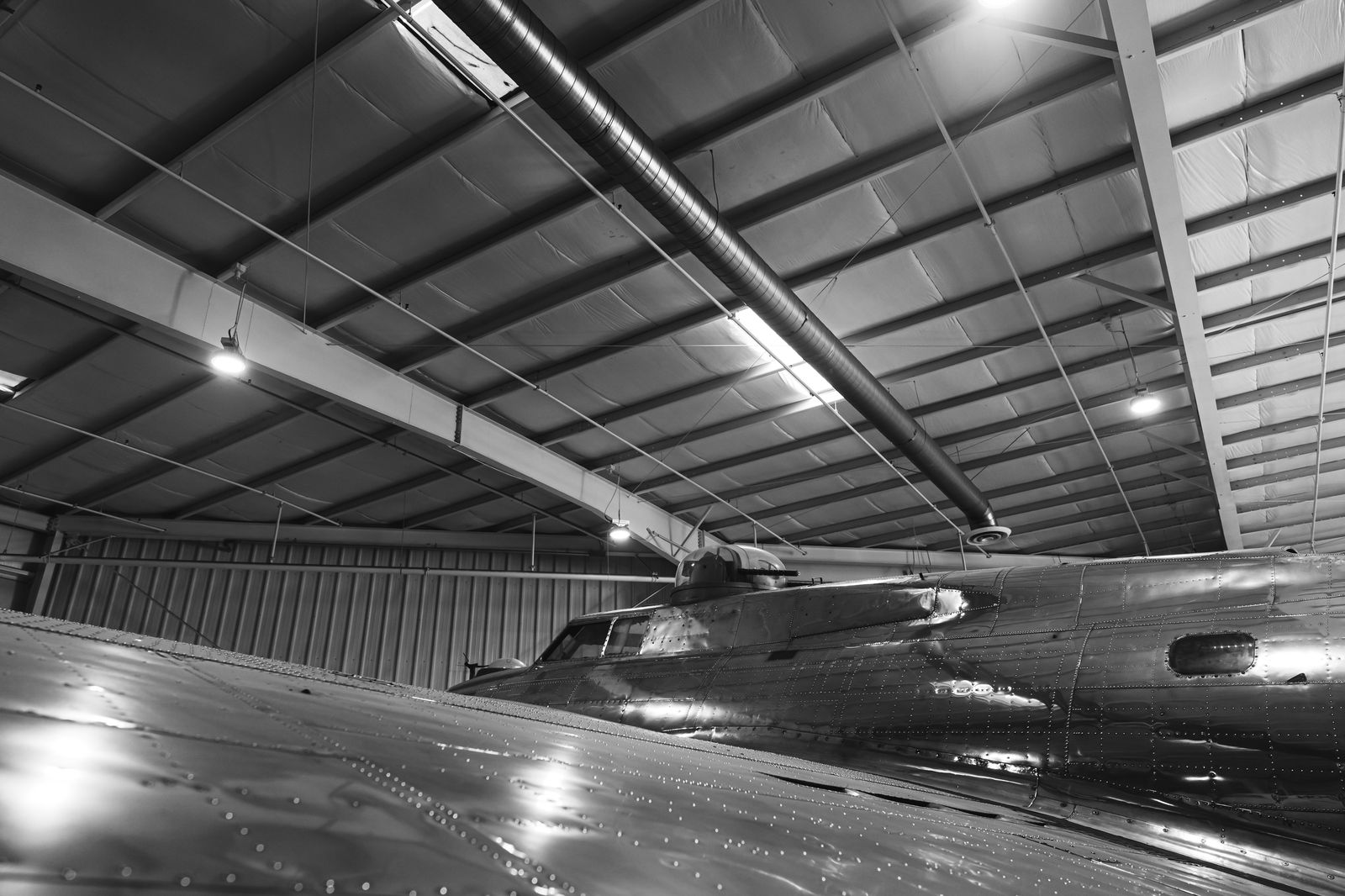 A business jet parked inside a hangar