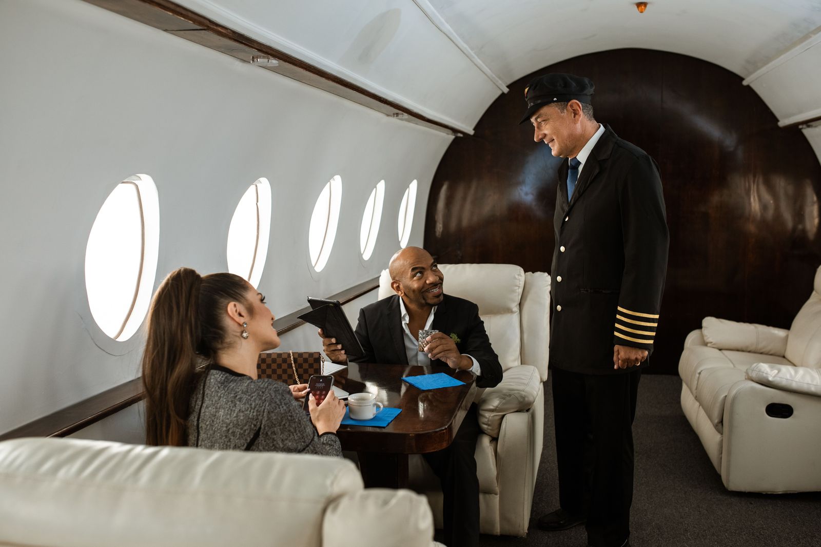 Flight crew walking across an airport apron toward a private jet
