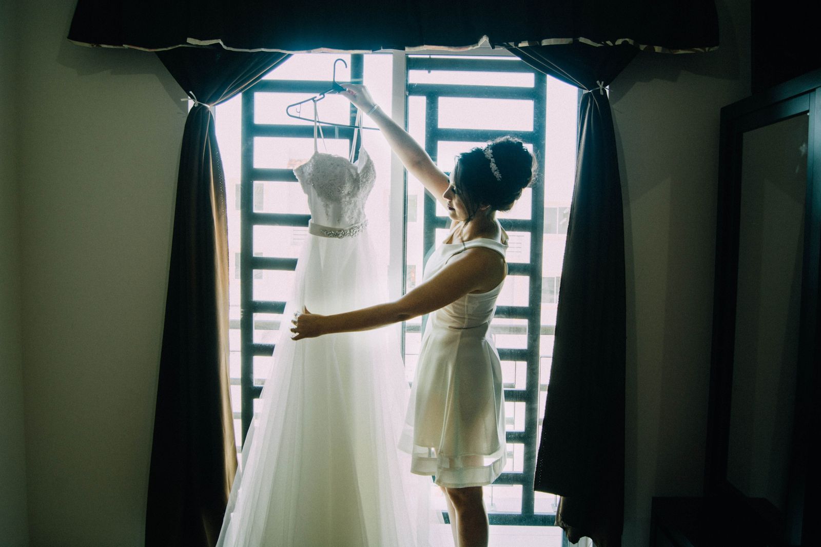 A bride checks the time while getting ready, with the wedding day timeline planned around each pickup