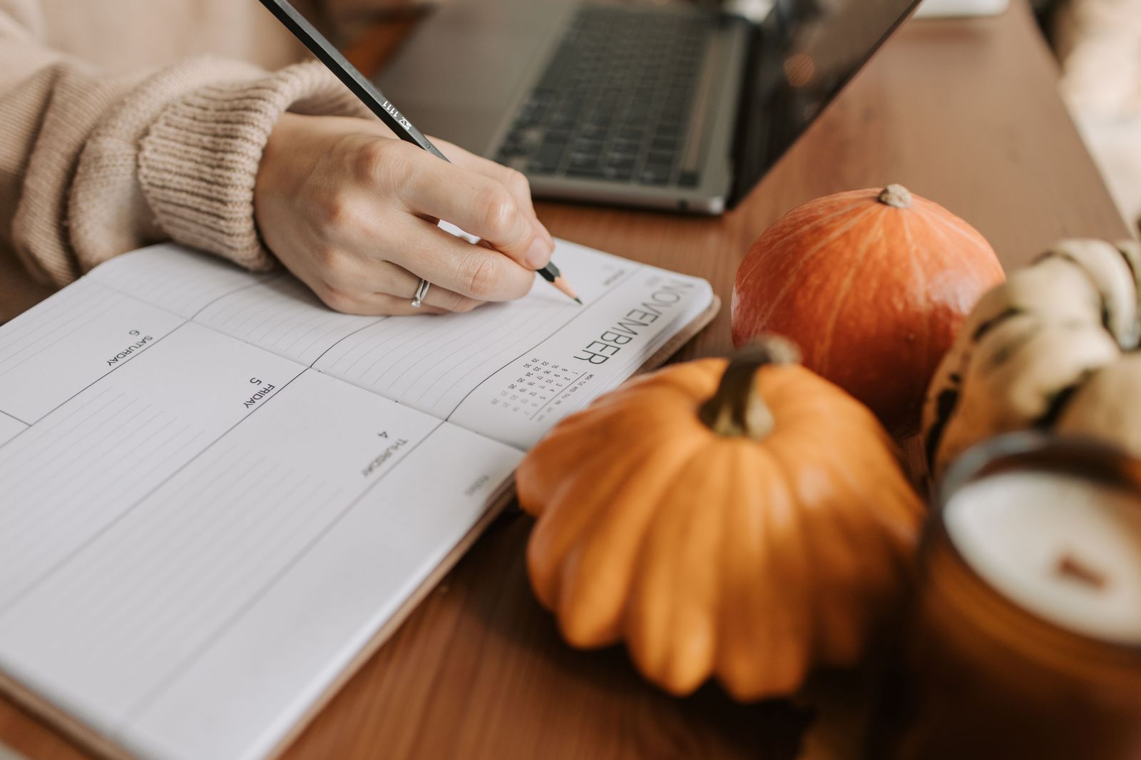 A wedding planner's notebook and calendar on a table, with the transport timeline written out by hour