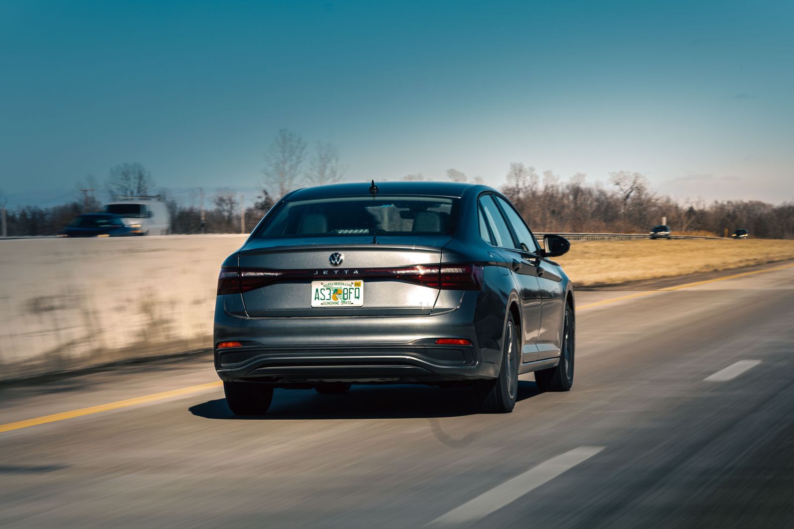 A black business sedan on Highway 403 at sunrise, heading from Brantford to the airport