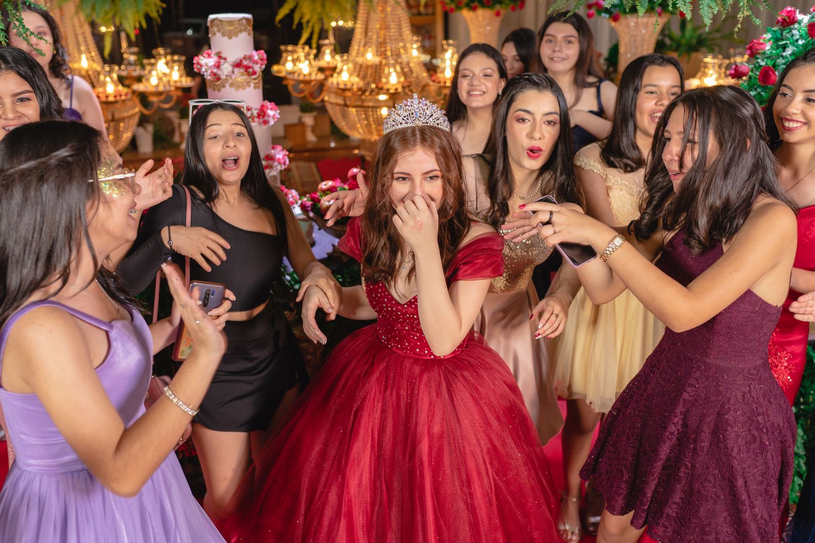 Teenage friends in party dresses celebrating a sweet sixteen
