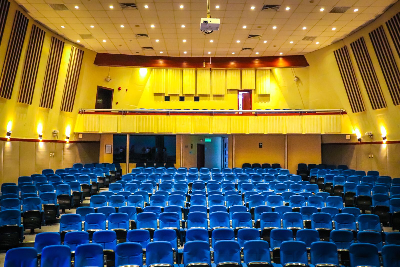 A conference hall with an audience and stage lighting during a corporate event