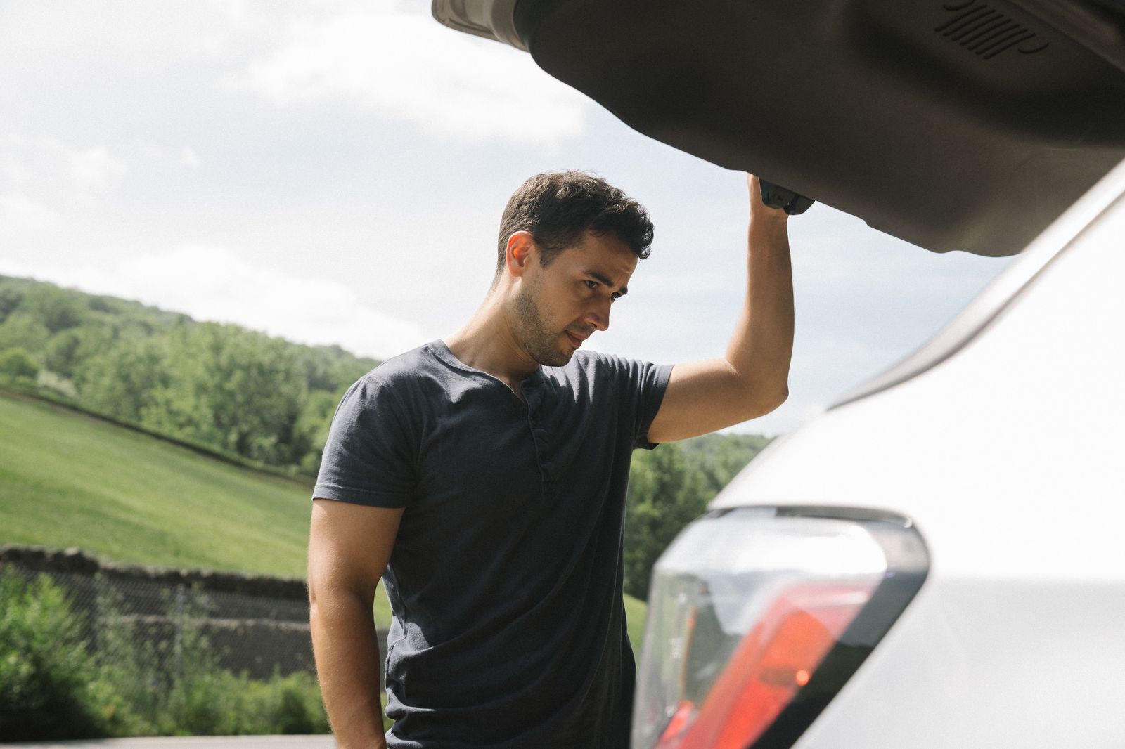 Chauffeur loading suitcases into the trunk for a Pearson airport to Hamilton transfer