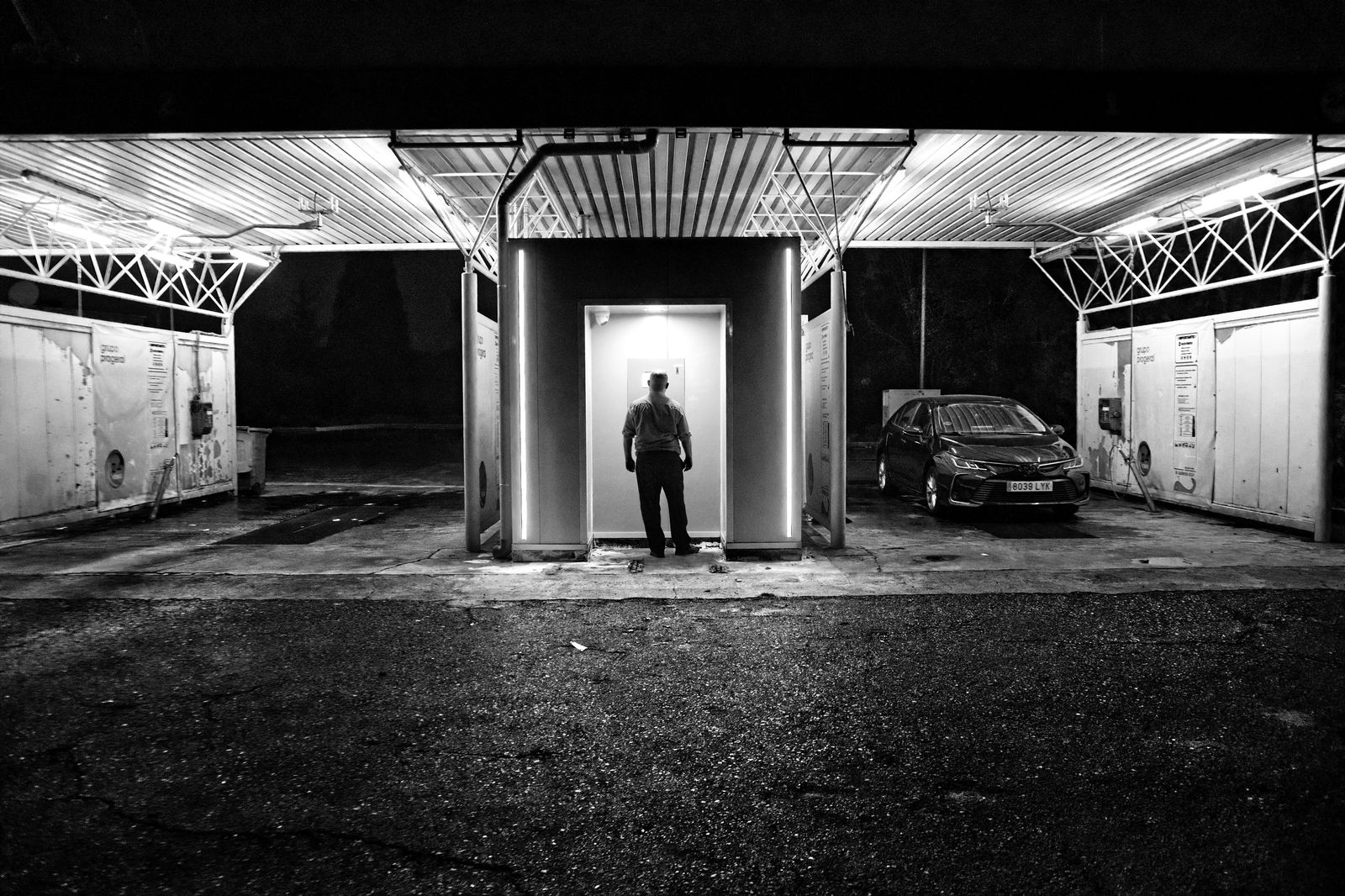 Black car waiting on a city street outside Union Station at night