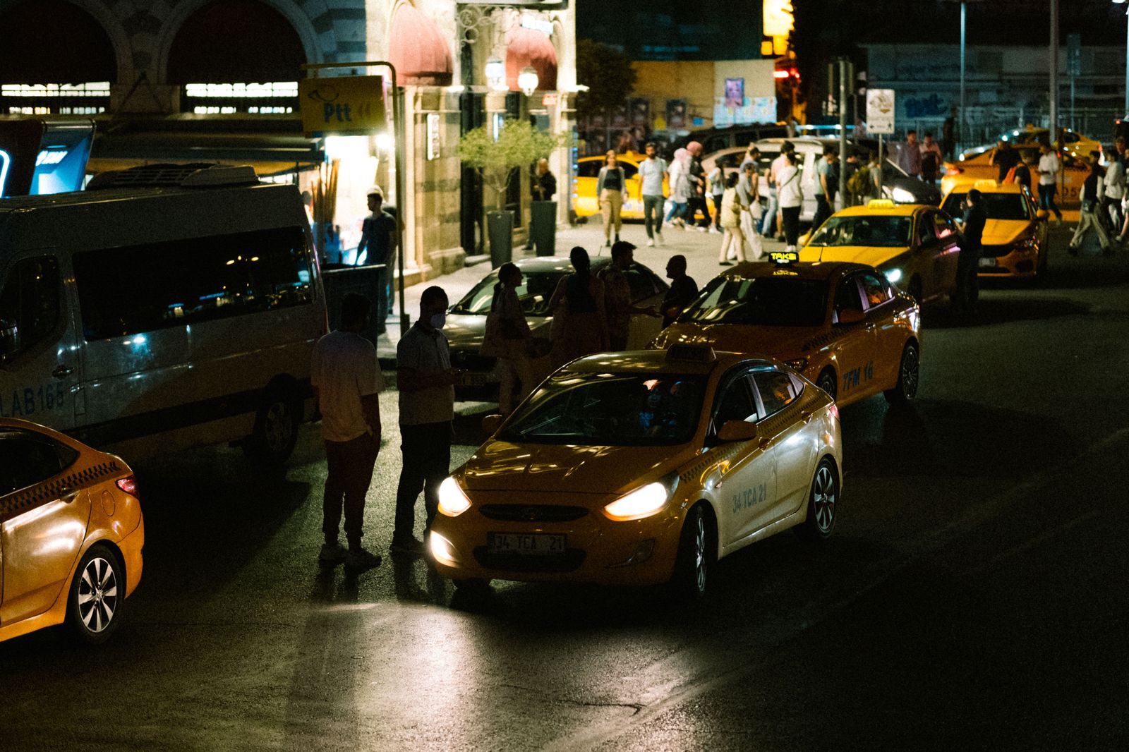 A line of taxis at an airport rank at night, the unbooked option for arriving travellers