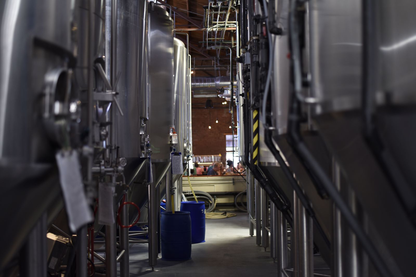 Stainless steel fermentation tanks in a craft brewery taproom