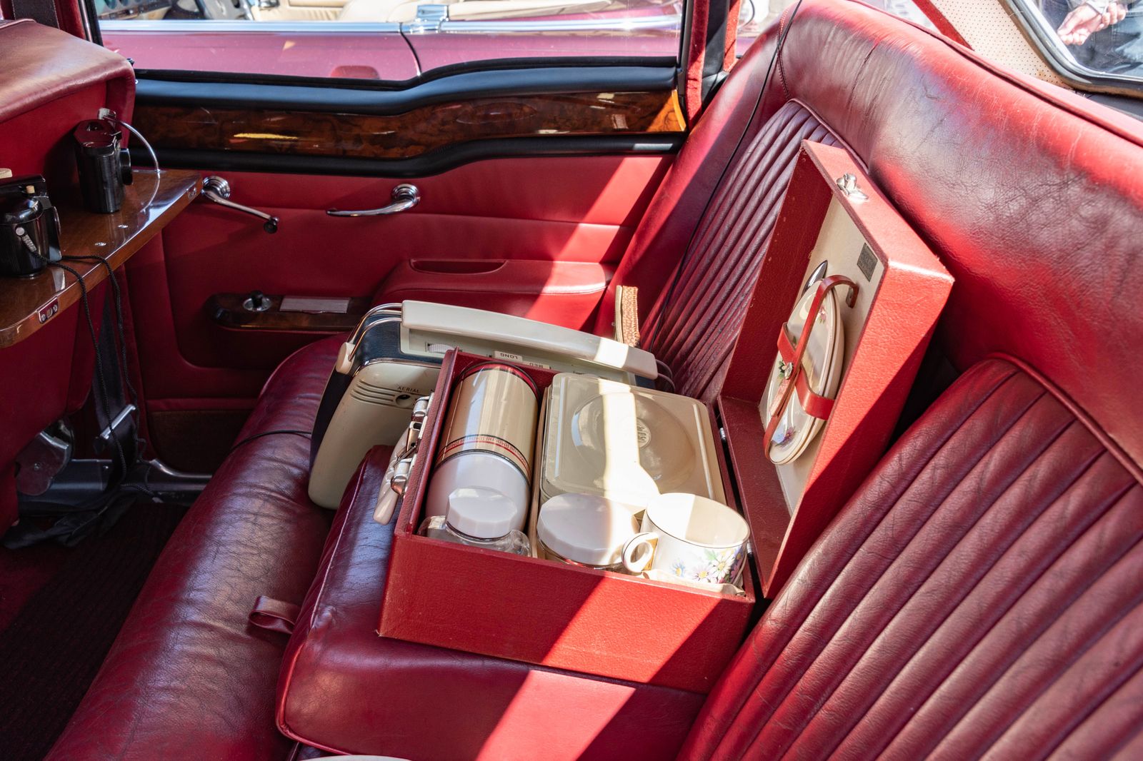 The leather rear seat of a luxury chauffeured car prepared for passengers