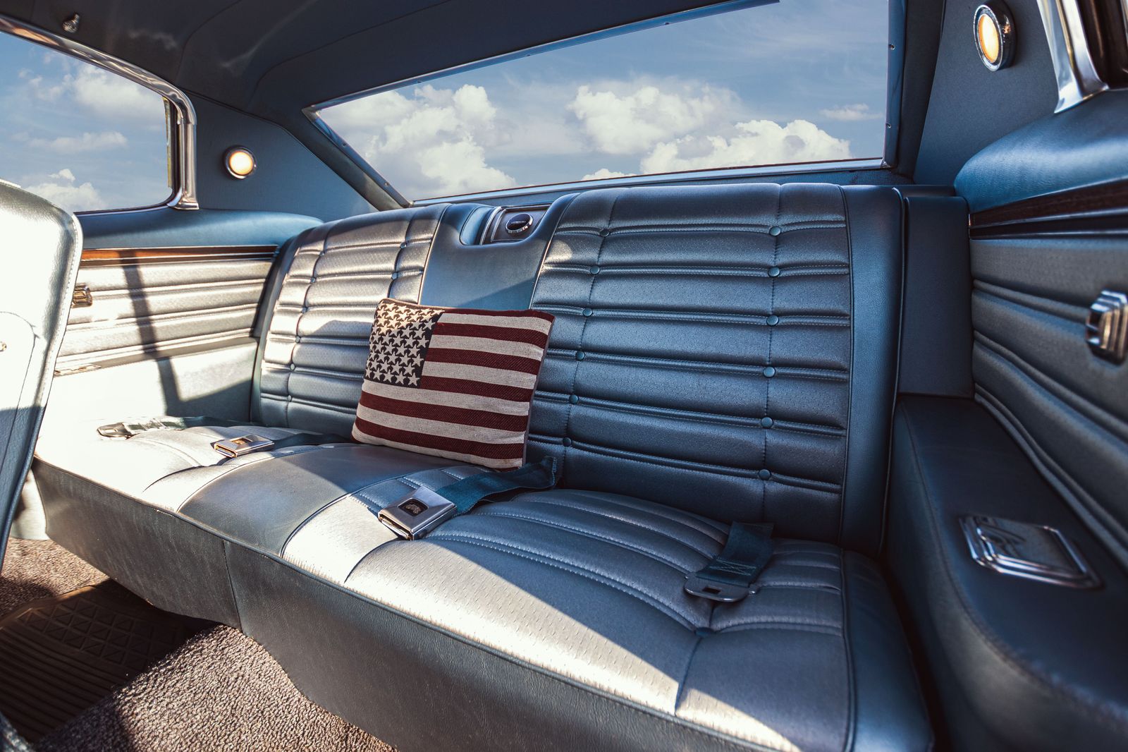 Leather perimeter seating and mood lighting inside a stretch limousine